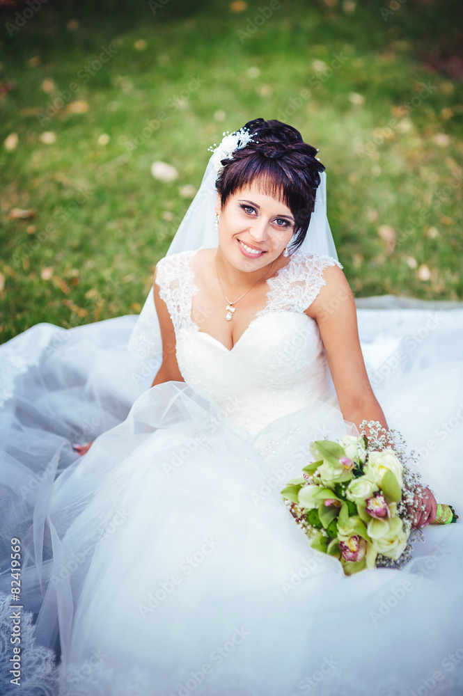 portrait of beautiful young bride holding bright bouquet in portrait of beautiful young bride holding bright bouquet in