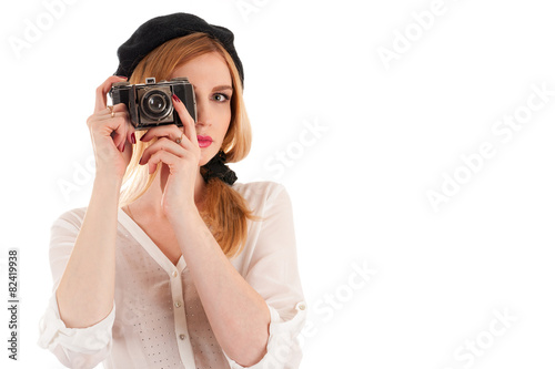 beautiful fashionable woman photographing retro camera