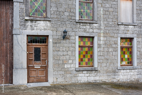 Ancient house with brick wall and colorful windows