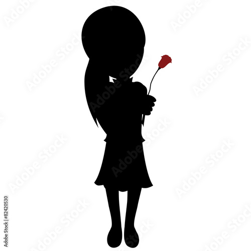 Silhouette of a lovely little girl gives a red rose