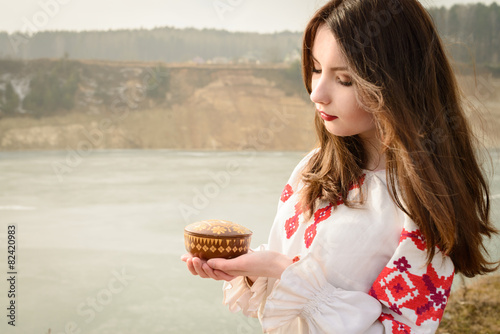 young woman in Slavic Belarusian national original suit outdoors