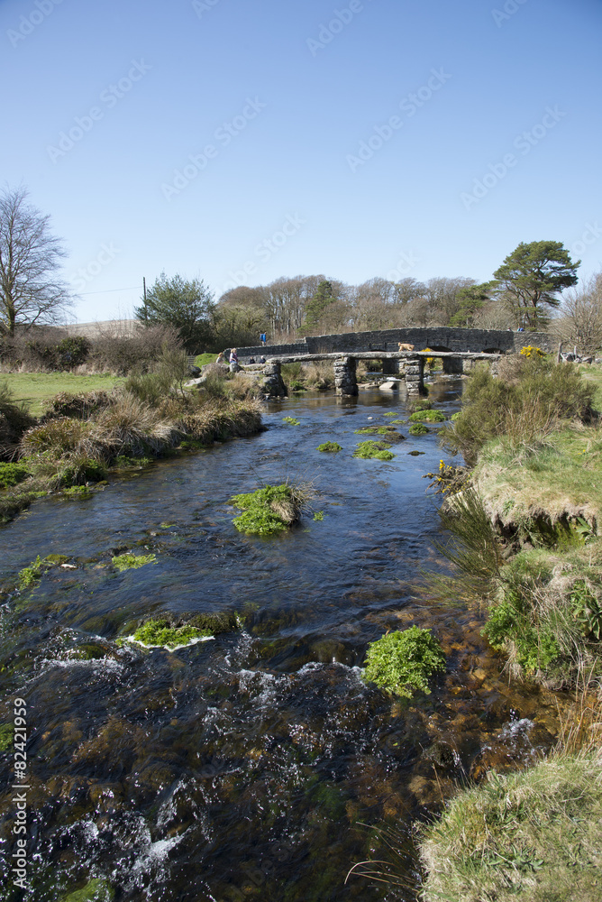 Ancient Clapper bridge at Postbrige on Dartmoor Devon UK