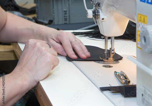 hands of the woman at the needlework of the colt case