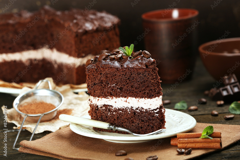 Delicious chocolate cake on table on brown background