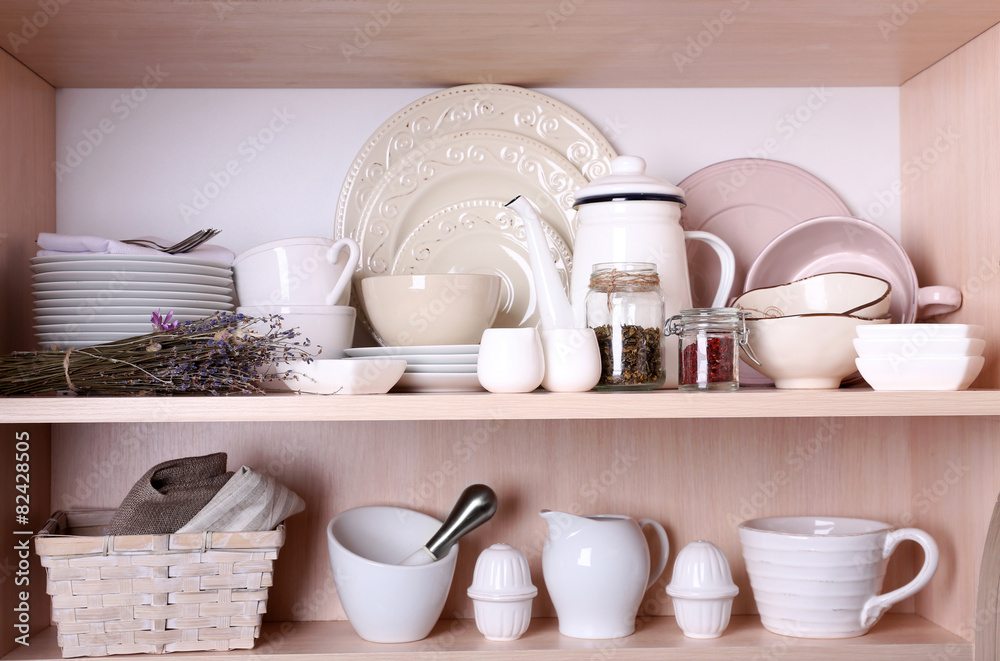 Kitchen utensils and tableware on shelves Kitchen utensils and tableware on shelves
