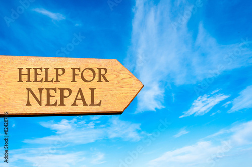 Wooden arrow sign with message HELP FOR NEPAL