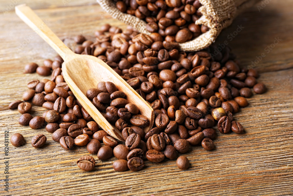 Coffee beans on wooden table, closeup Coffee beans on wooden table, closeup