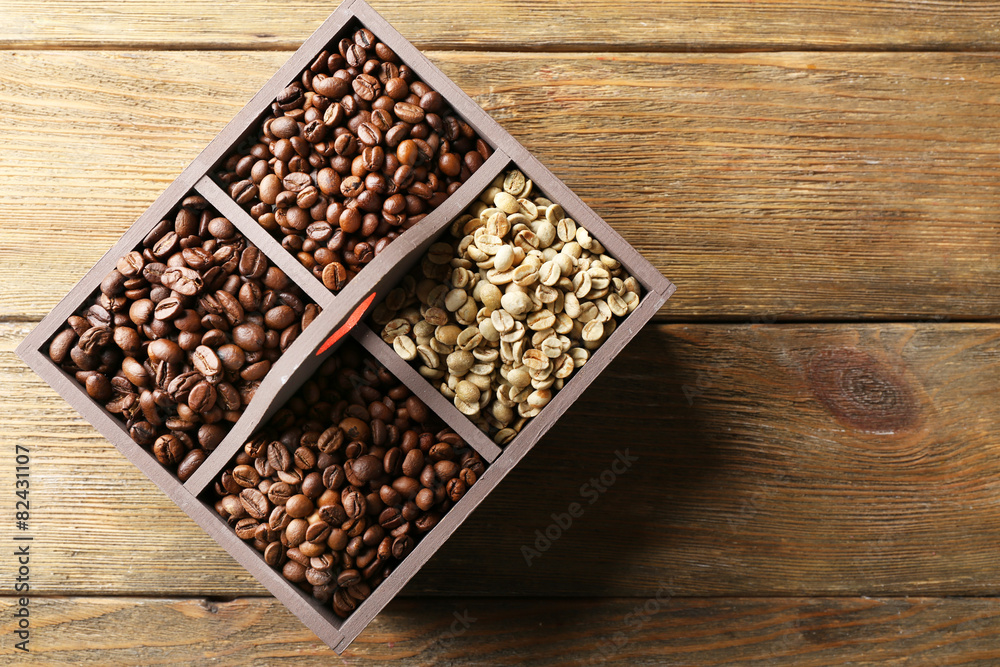 Coffee beans in box on wooden table, top view Coffee beans in box on wooden table, top view