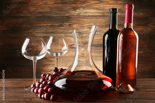 Foto Glass carafe of wine on wooden background