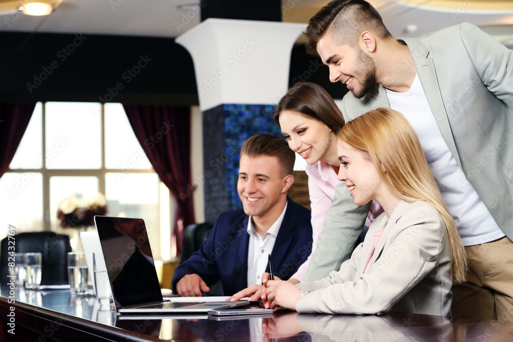 Businesswoman and business people working at notebook in conference room