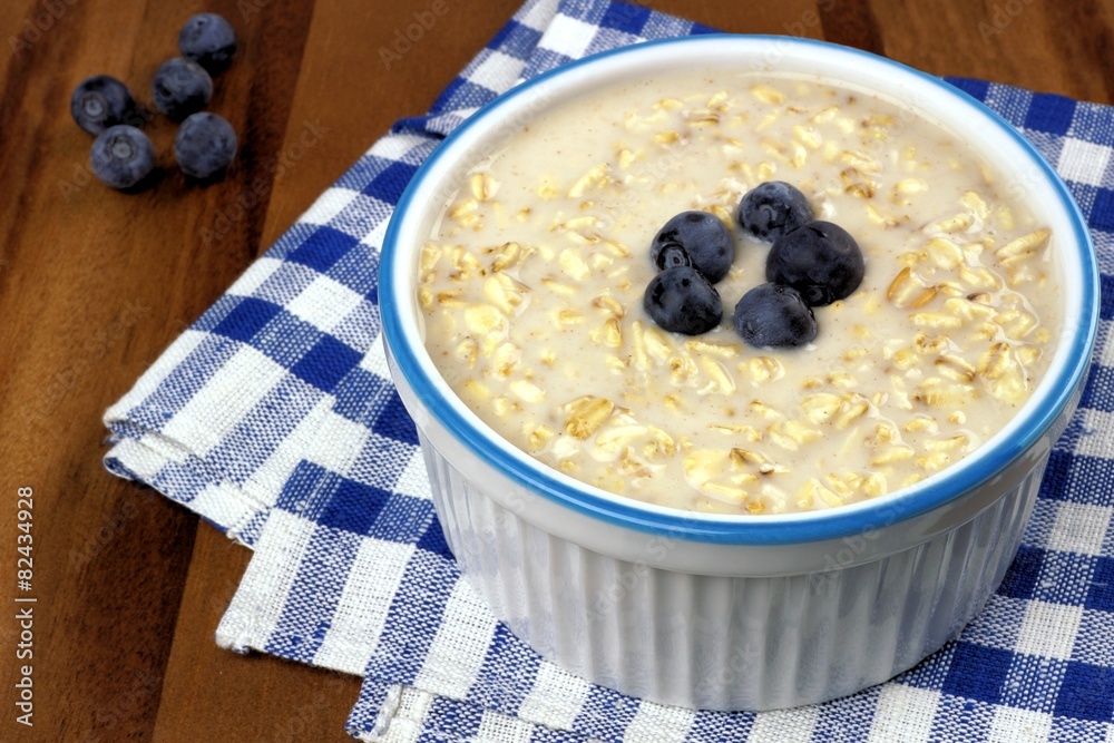 Breakfast oatmeal bowl with milk and blueberries Breakfast oatmeal bowl with milk and blueberries
