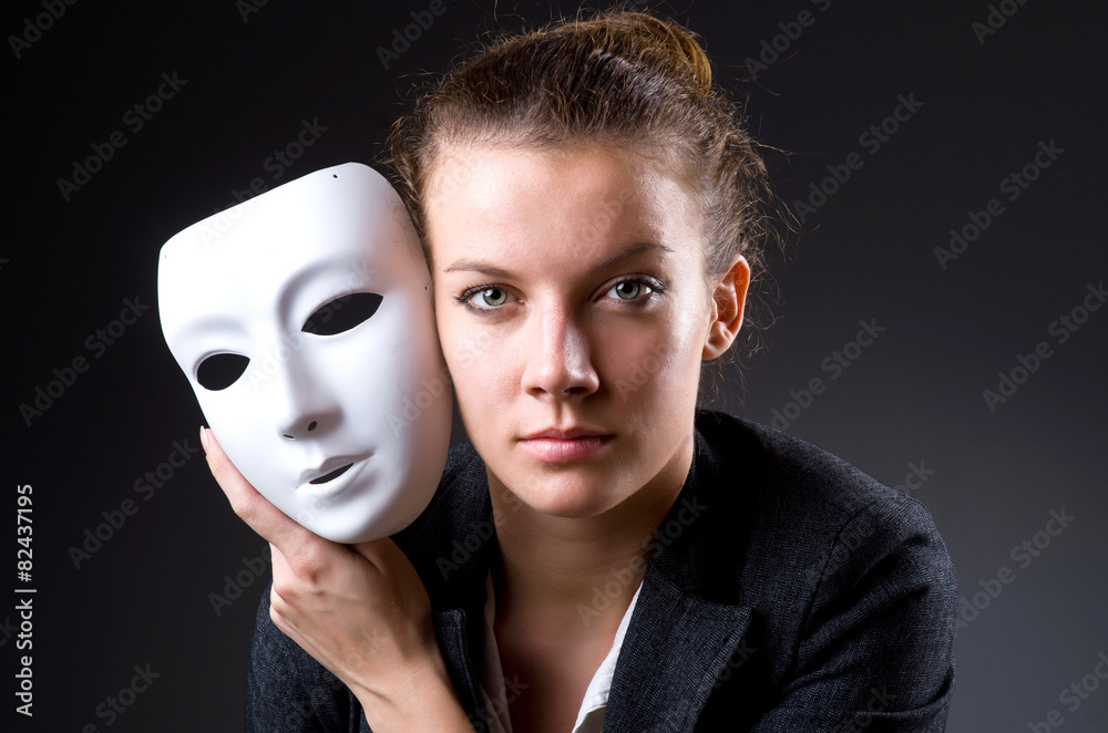 Woman with mask in hypocrisy concept Woman with mask in hypocrisy concept