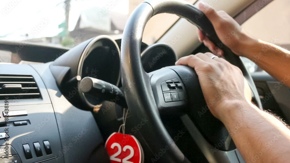 Close up of nervous male hands on steering wheel