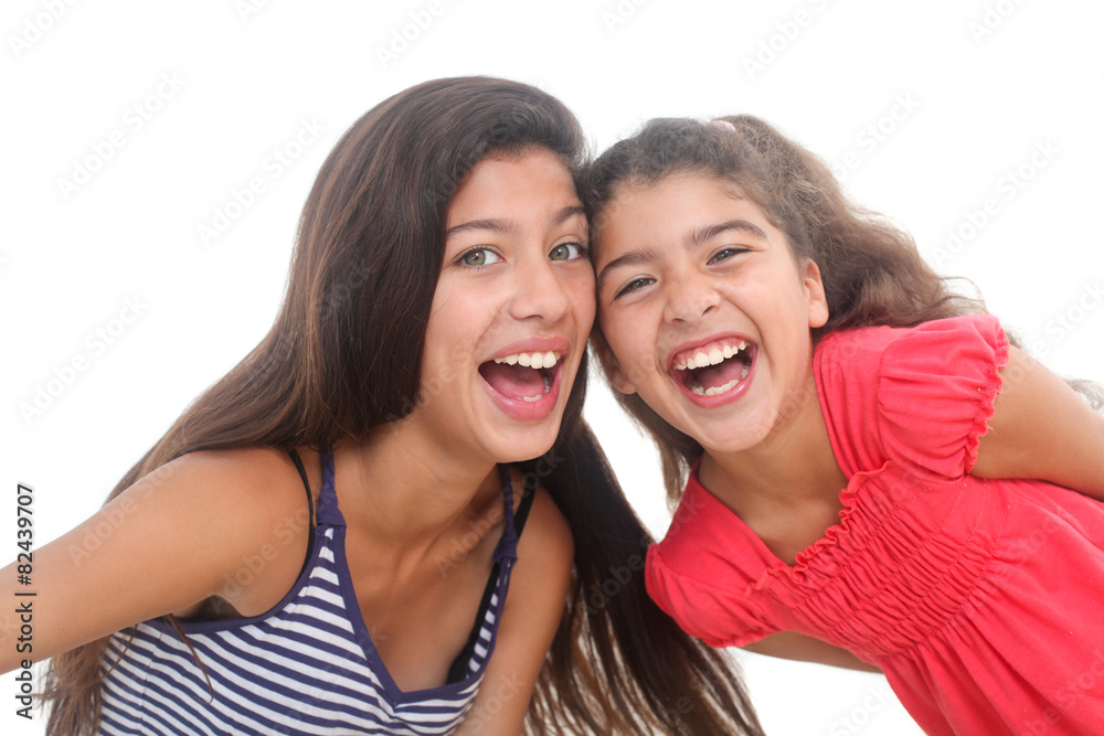 portrait of two happy girls on white background portrait of two happy girls on white background