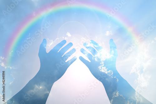 Hand on Blue sky with rainbow