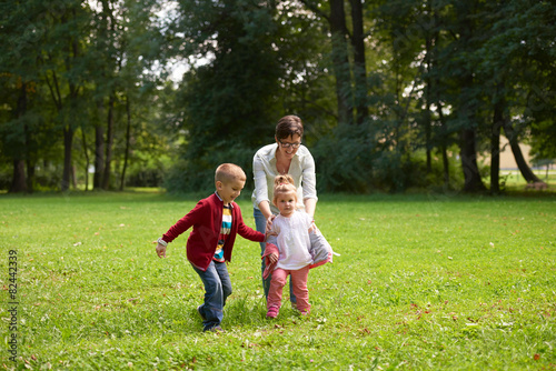 happy family playing together outdoor in park