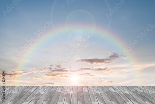 old wooden texture and rainbow  with lens flare in blue sky 