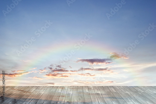 Fotografie old wooden texture and rainbow in blue sky