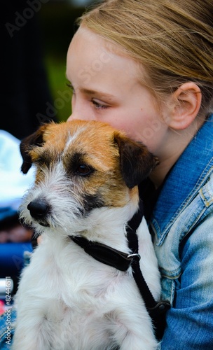 Dog sitting in a girls lap photo