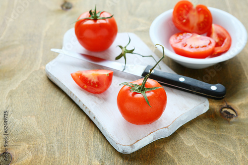fresh juicy tomatoes on a white board