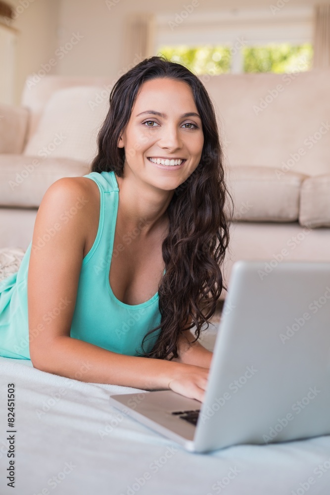 Pretty brunette using her laptop Pretty brunette using her laptop