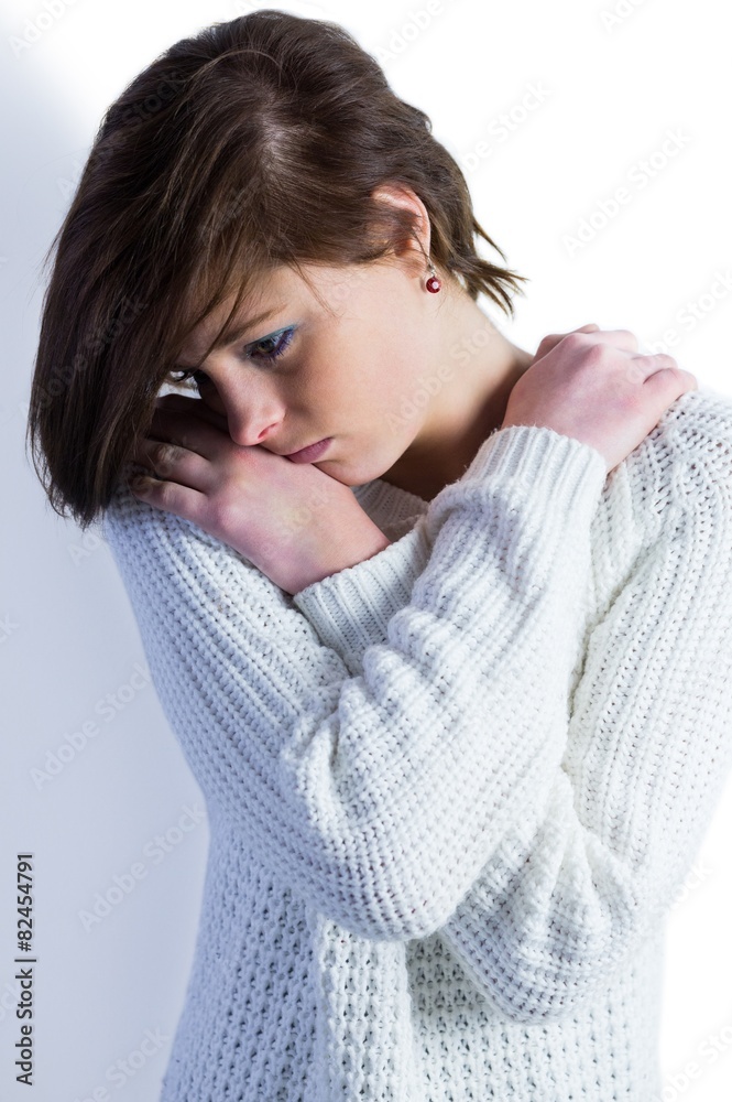 Sad pretty brunette thinking with arms crossed Sad pretty brunette thinking with arms crossed