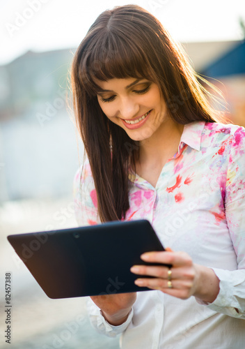 Mobilty - woman with tablet on street