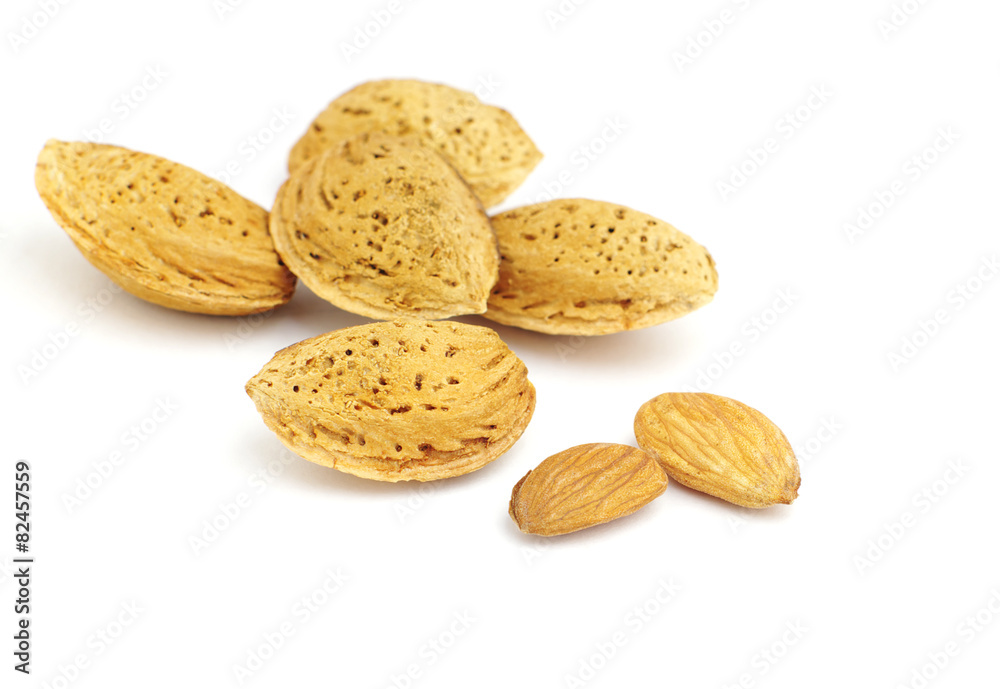 Almonds peeled and in-shell, on white, shallow DOF. Almonds peeled and in-shell, on white, shallow DOF.