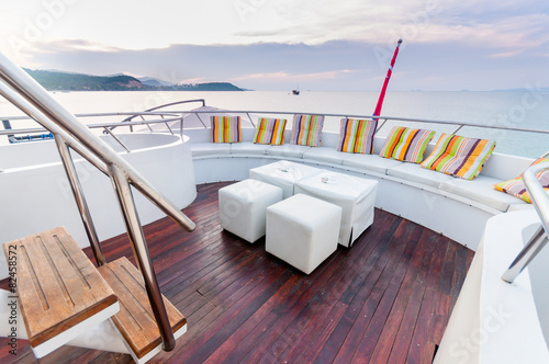 White stools and long seat on the yacht deck © normalfx