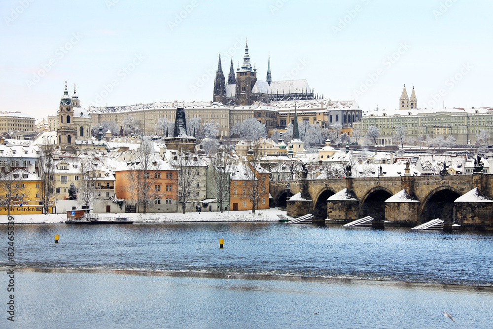 Snowy Prague with gothic Castle and Charles Bridge