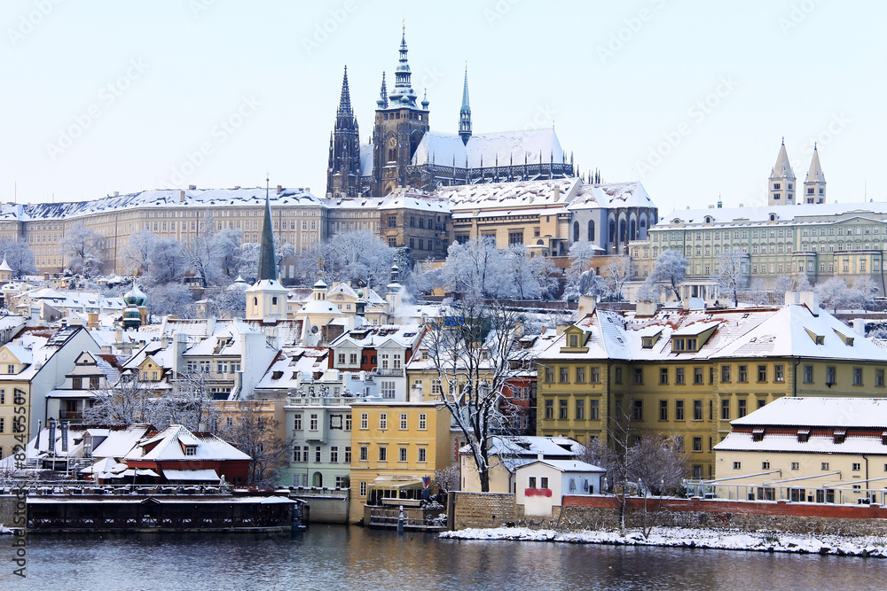 Fototapeta premium Snowy Prague gothic Castle above River Vltava