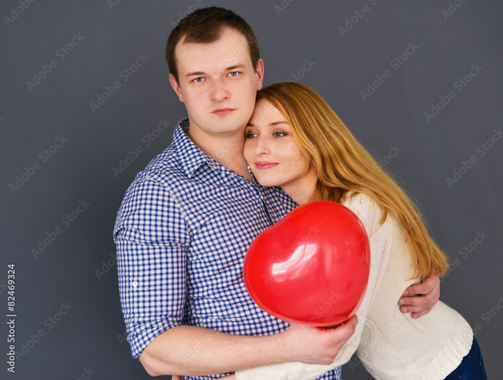 Beautiful couple in love with red balloon heart Beautiful couple in love with red balloon heart