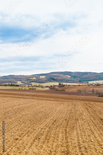 Agricultural field with soil and blue sky