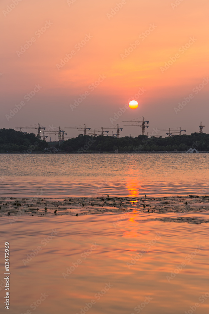 Sunset on a background of high-rise buildings and construction s