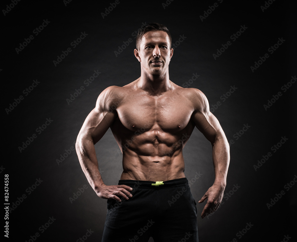 Fototapeta premium Muscular man in studio on dark background