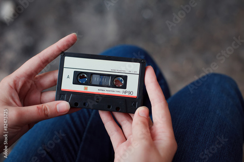 Beautiful girl with a cassette in her hands