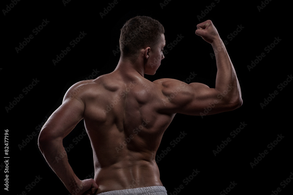 Obraz premium young athlete bodybuilder from back