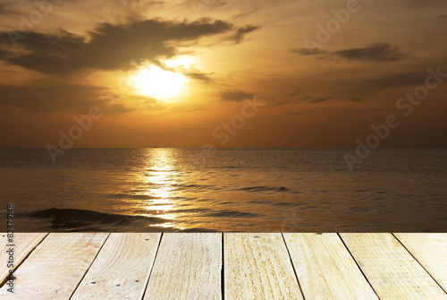 Wood terrace and Cloudy orange sunset over sea © itim2101