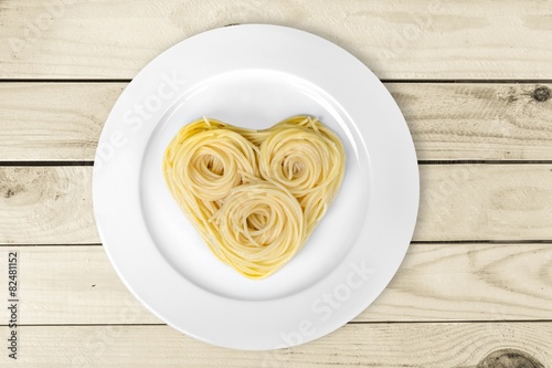 Pasta. Cooked spaghetti carefully arranged in heart shape and