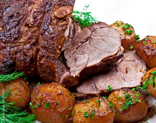 Roast leg of lamb on white background.