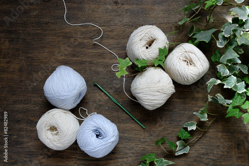 Ball of cream and blue yarn with crochet hook