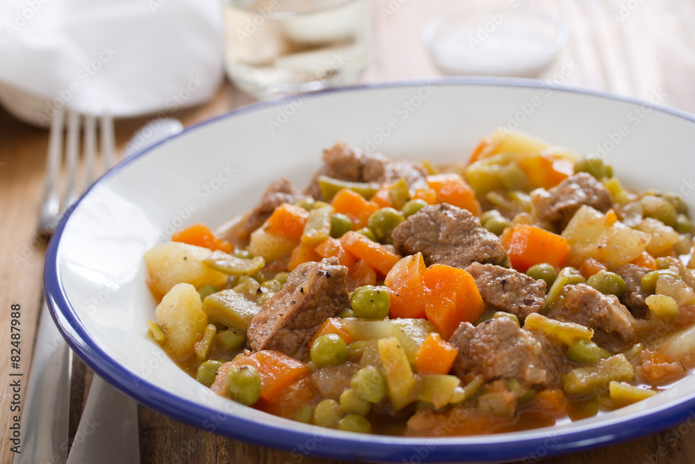 meat with carrot, peas and potato on plate meat with carrot, peas and potato on plate