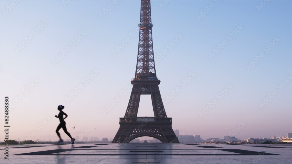 woman running in front of the Eiffel tower