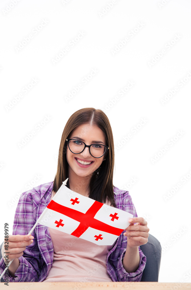 Smiling woman sitting at the table with Georgians flag Smiling woman sitting at the table with Georgians flag