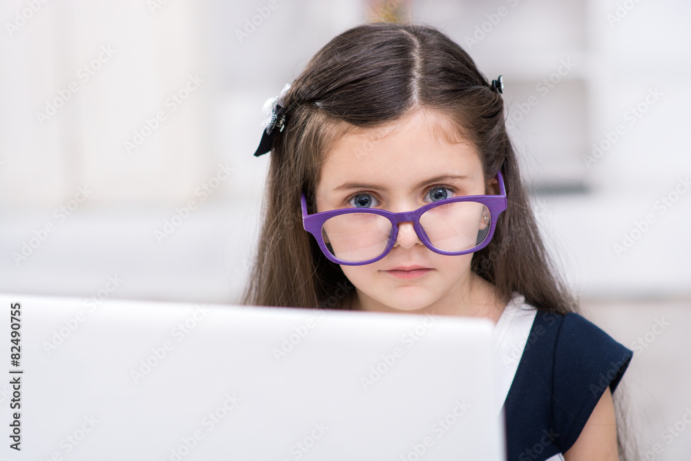 Little dark-haired girl playing role of business woman Little dark-haired girl playing role of business woman