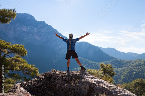 Sportsman on the top of rock. Sport and active life concept © Kotangens