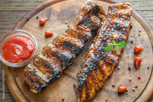 Grilled pork ribs with tomatoes on the wooden board