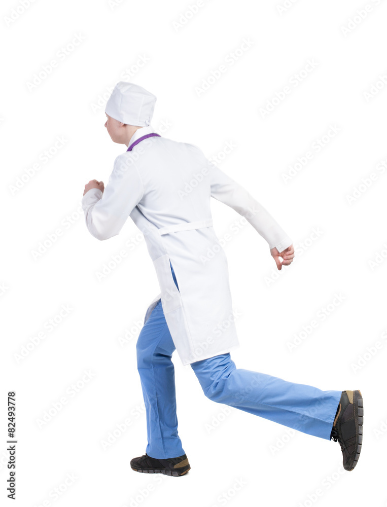 Back view of running doctor in a robe hurrying to help the patie Back view of running doctor in a robe hurrying to help the patie