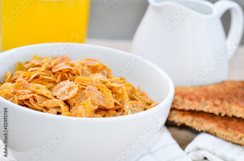 Breakfast cereal with toast and juice.