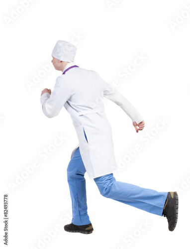 Back view of running doctor in a robe hurrying to help the patie